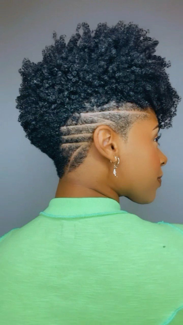 Profile showing dense curls above shaved curved side lines