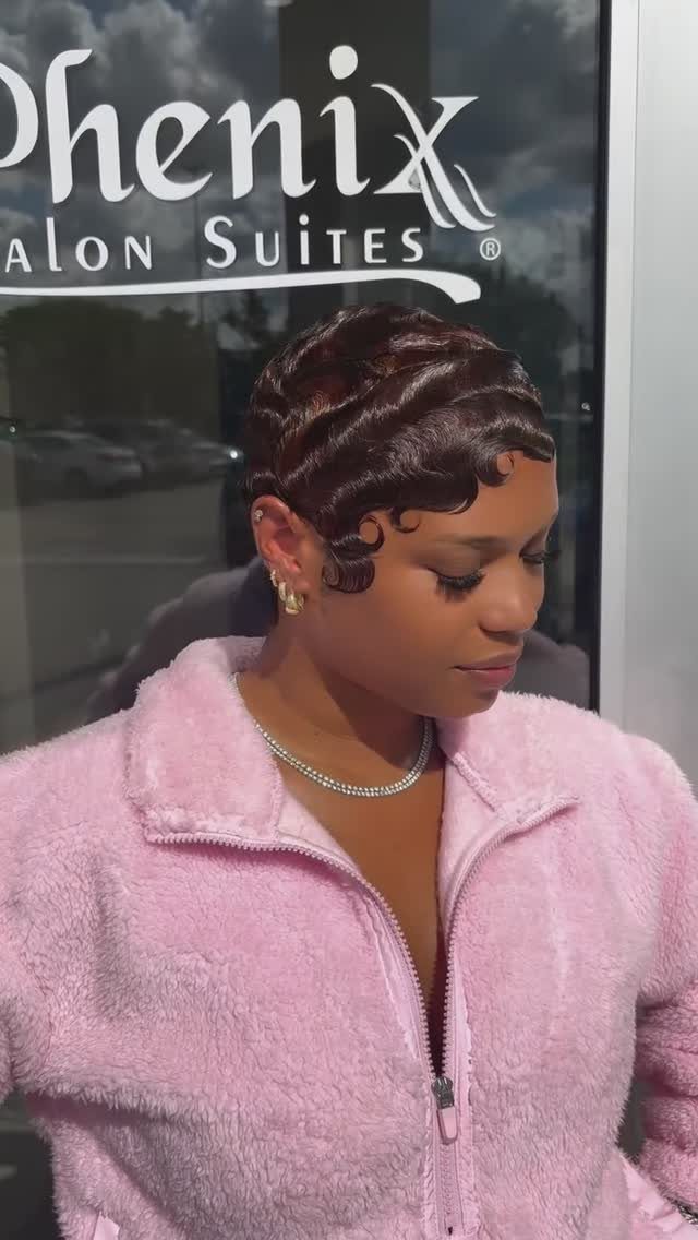 Woman showing glossy short finger waves outside a salon
