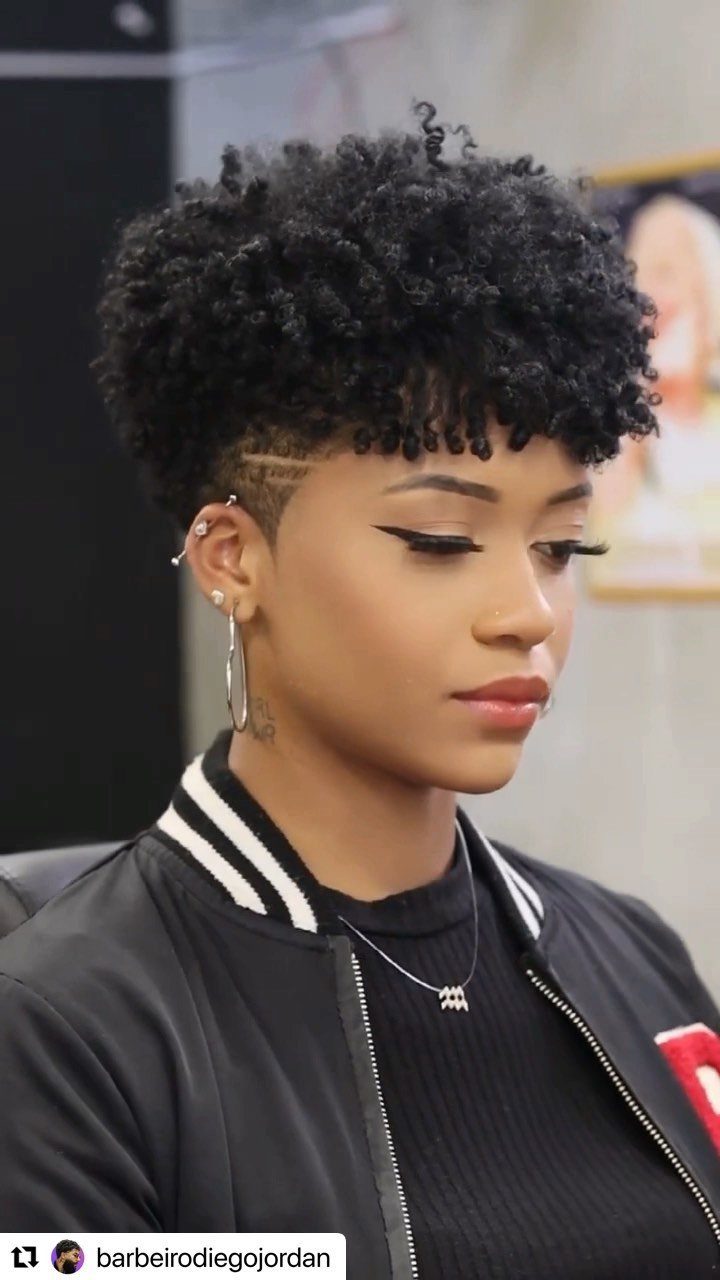 High curly top with closely tapered sides and a shaved line detail