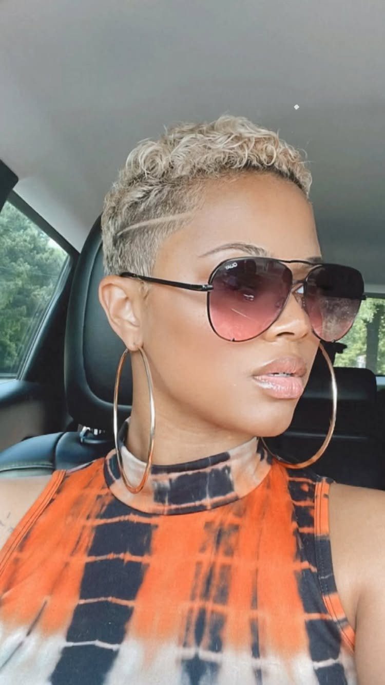 Short curly mohawk with cropped sides and shaved line