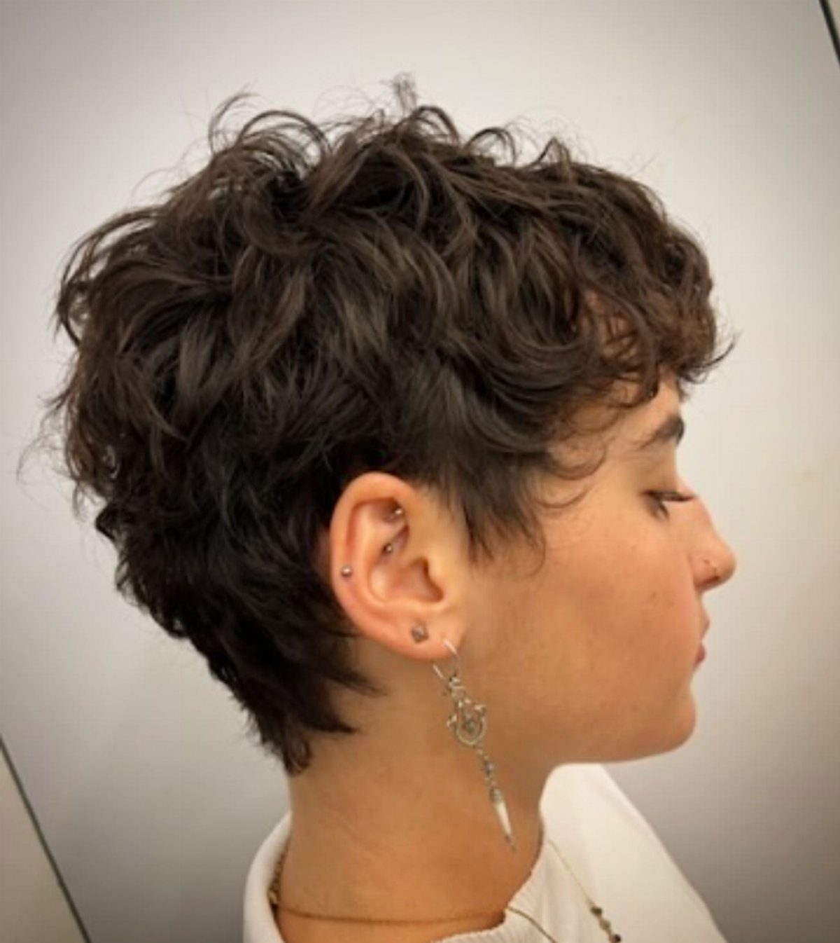 Short wavy pixie cut with tousled top and tapered sides