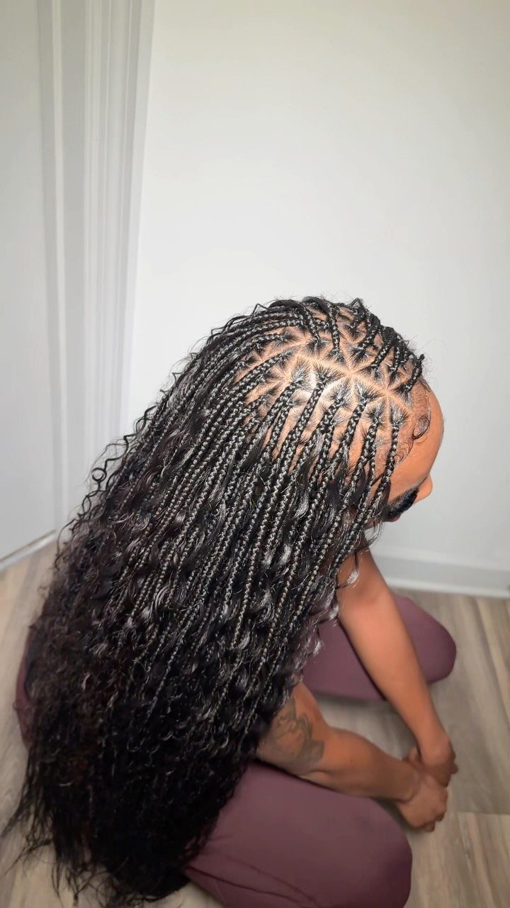 Long dark goddess box braids with curly strands and loose textured ends