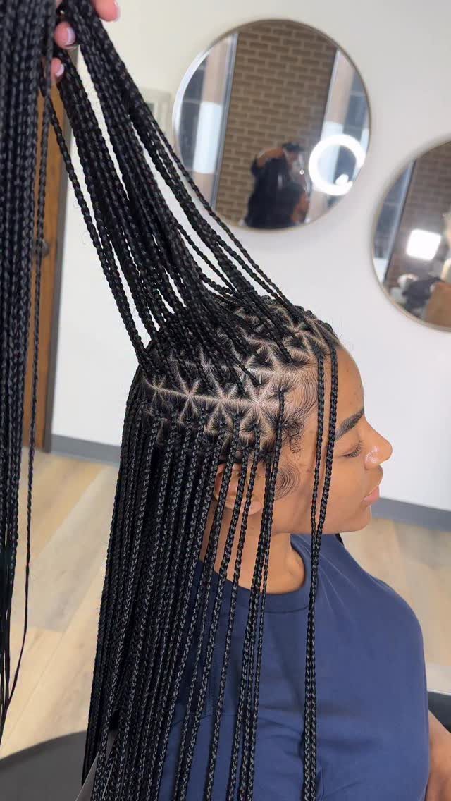 Woman with long black box braids showing triangular scalp sections