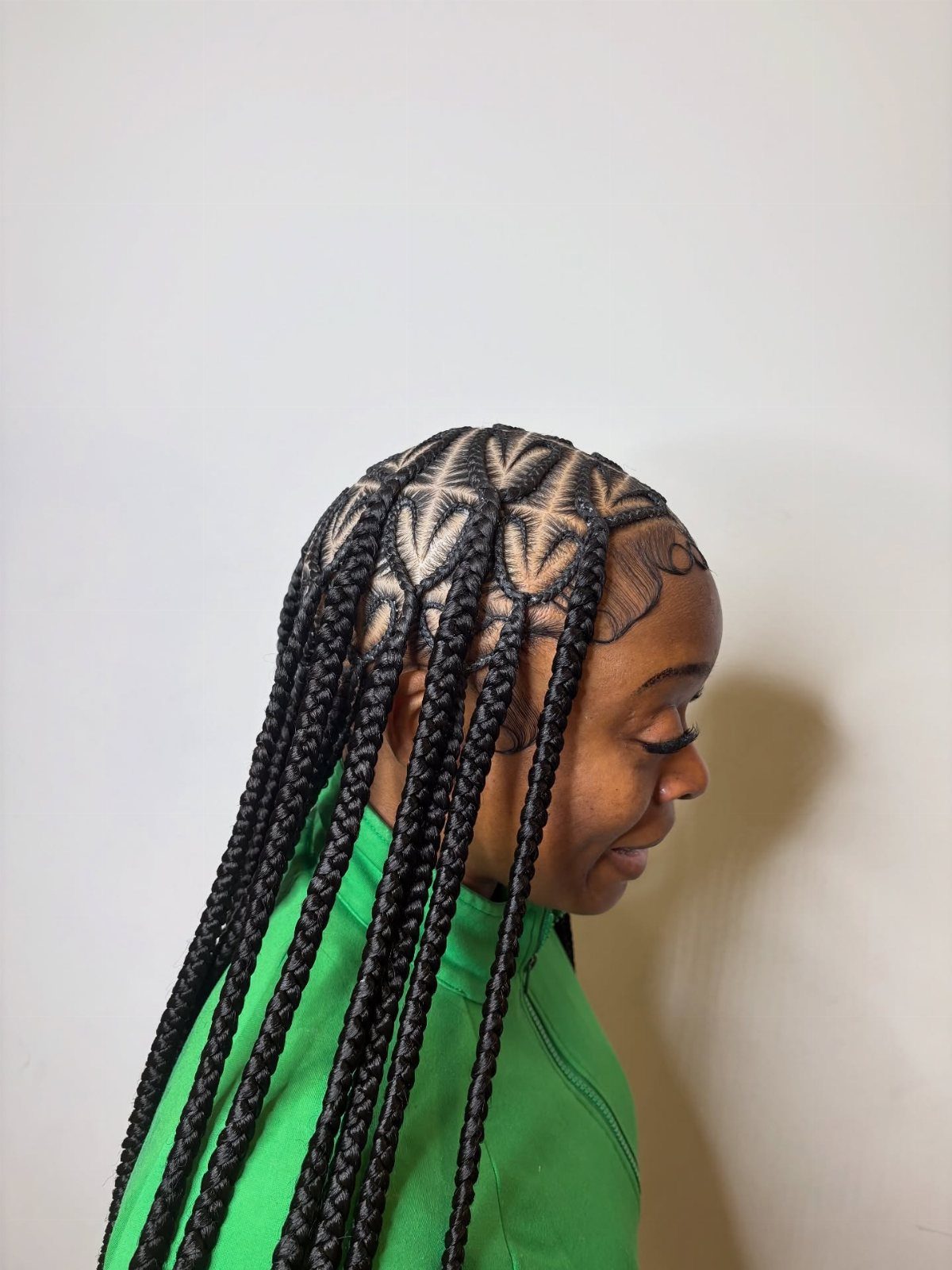Woman wearing long black braids with a heart-shaped scalp parting