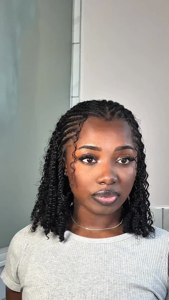 Woman wearing a shoulder-length curly bob with black twists