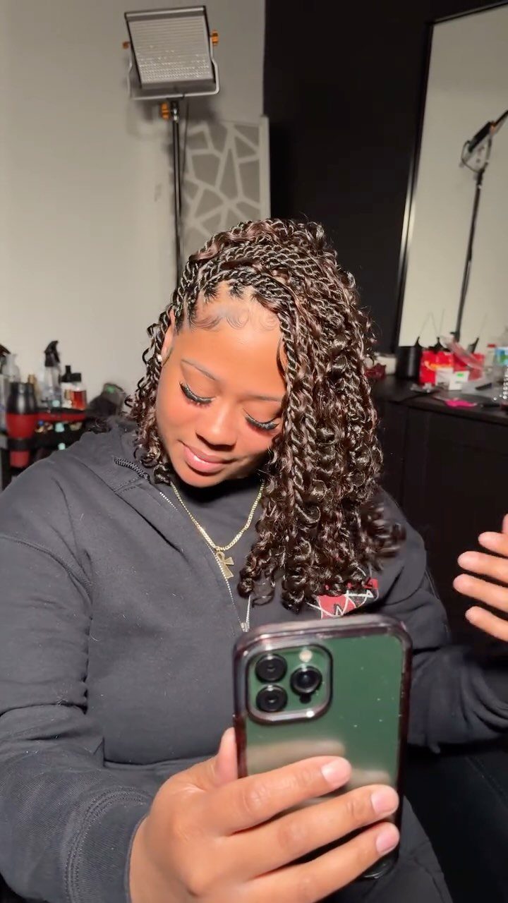 Woman showing long, loose bohemian Marley twists in a salon mirror selfie