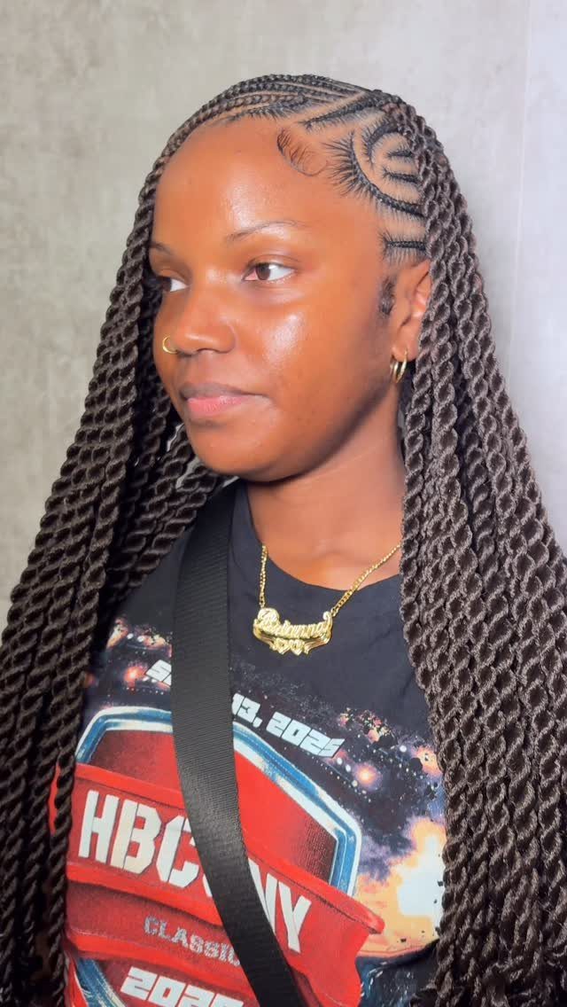 Long dark Marley twists fall over a graphic T-shirt, with a side part.