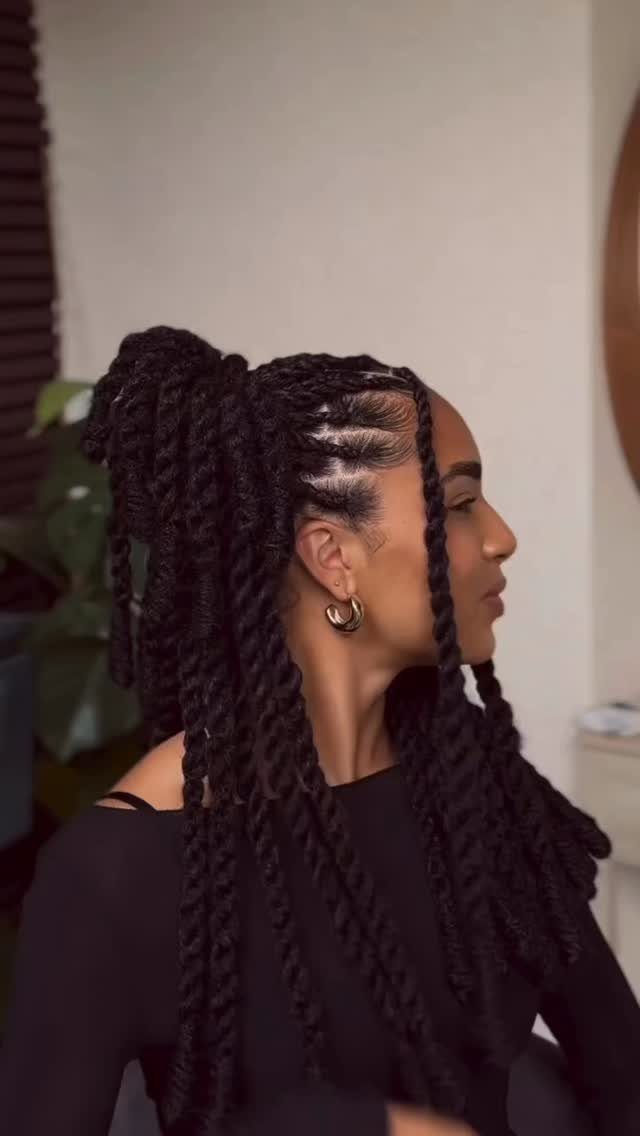 Woman displaying medium-length Marley twists gathered into a side ponytail