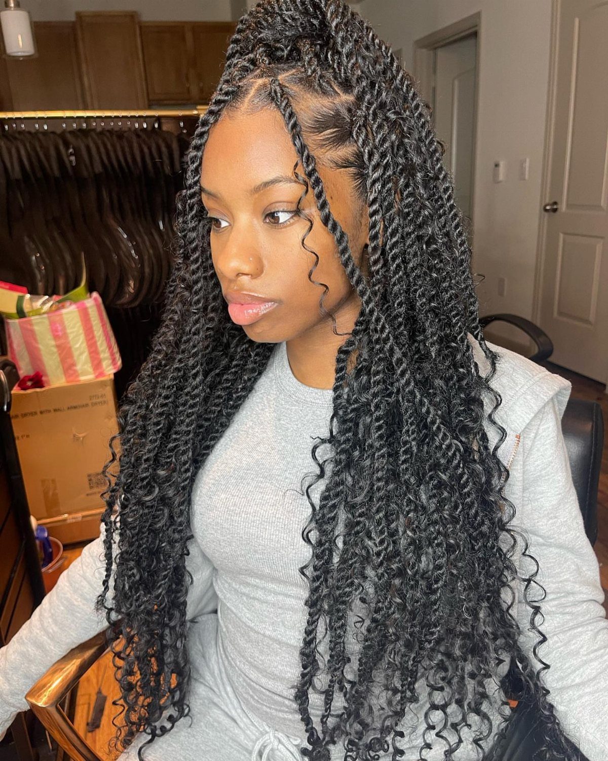 Person wearing long small Marley twists with front sections twisted back and curly ends