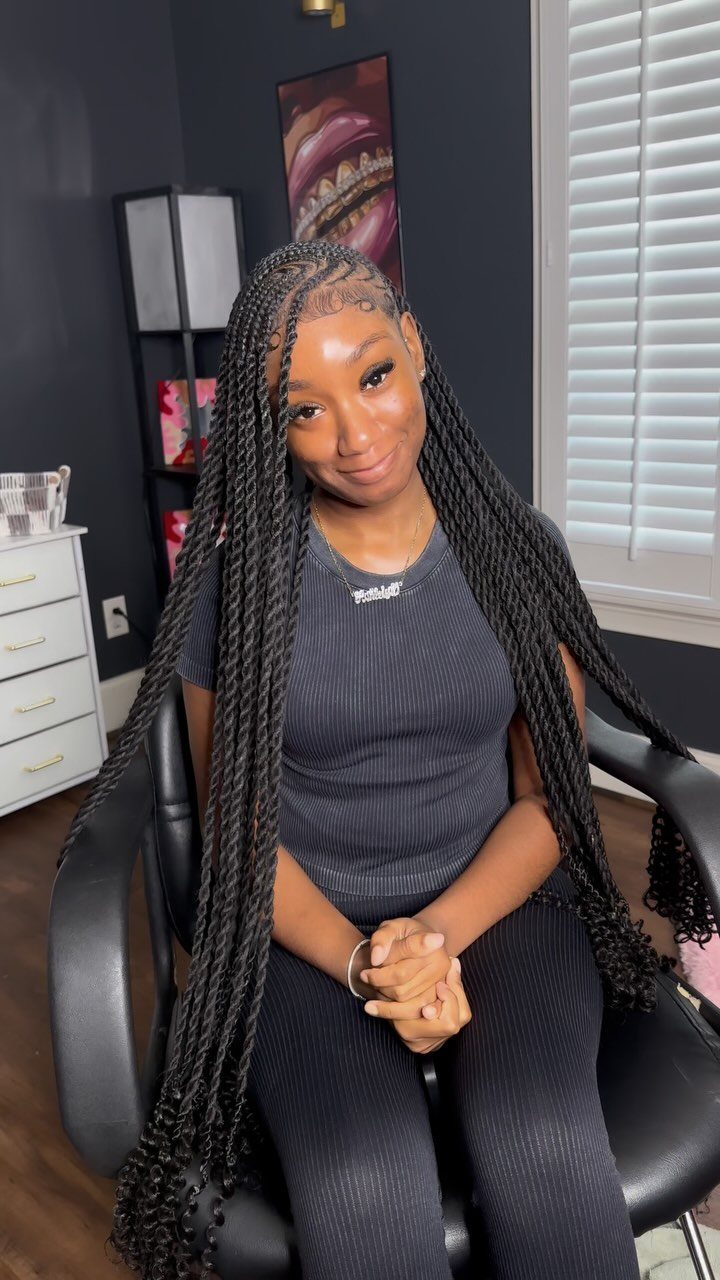 Woman seated in a salon displaying long box twists with neat square parts