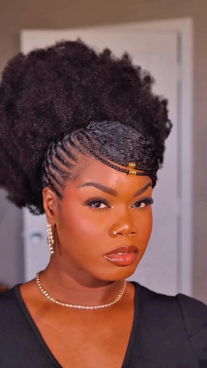 Woman wearing a flat-twist updo with voluminous natural twist-out bangs