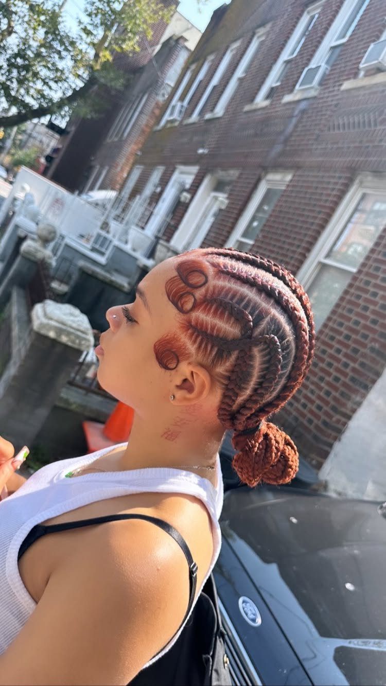 Woman with straight-back twists gathered into a low bun outdoors
