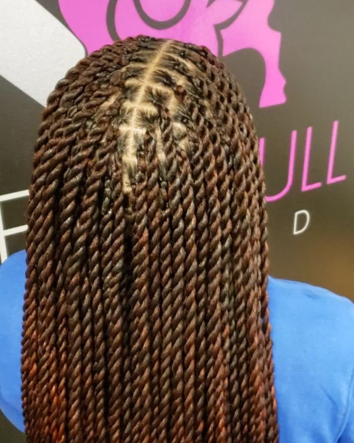 Long brown twists arranged in neat straight-back rows on a person's head