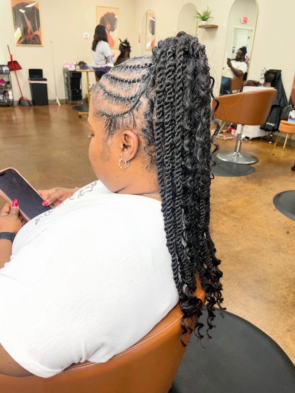 Woman wearing a long twisted ponytail with curved side parts in a salon