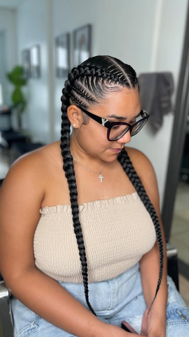 Woman showing two long braided hairstyles with detailed cornrow sections