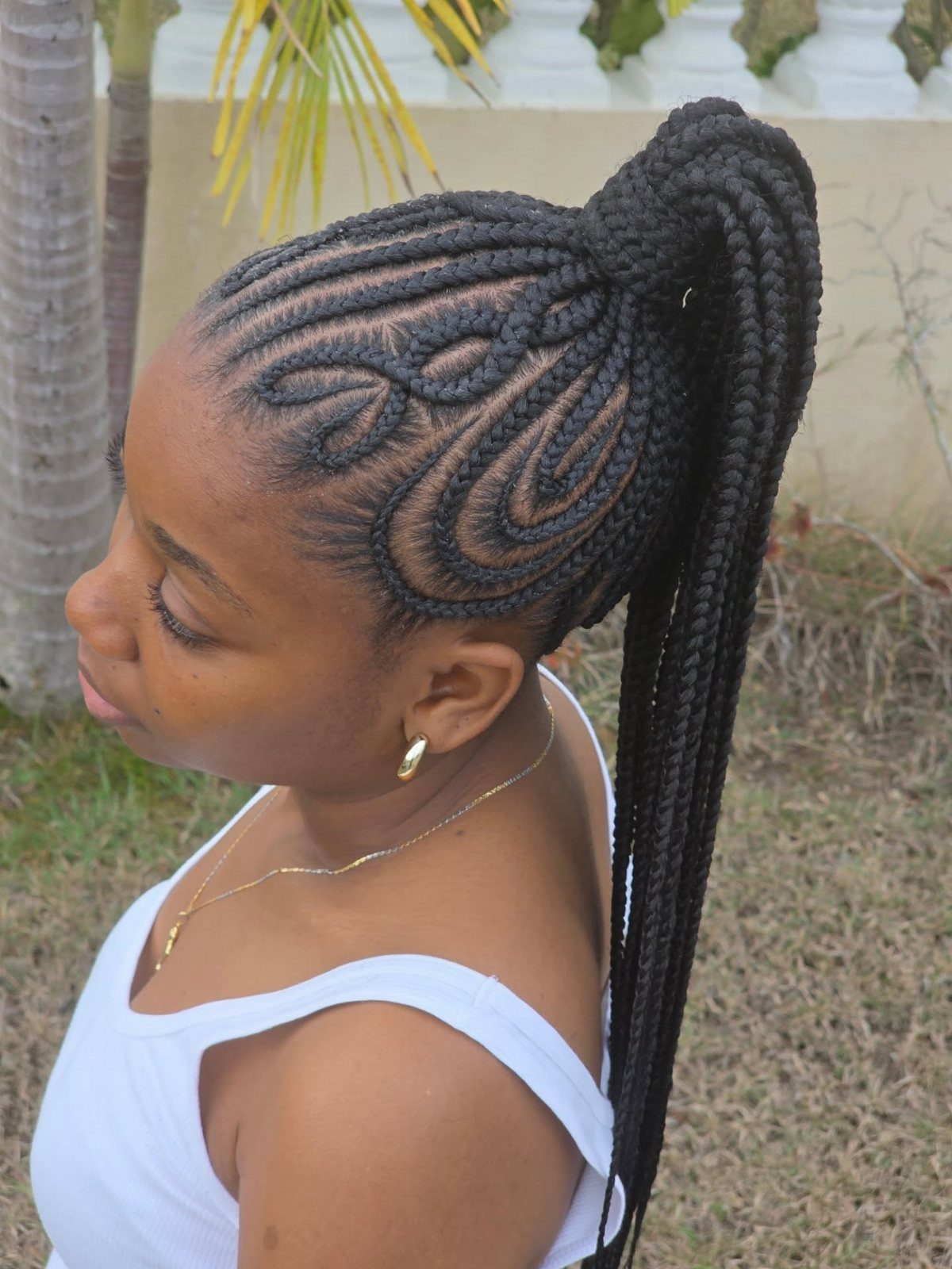 Lattice cornrows gathered into a high, long braided ponytail