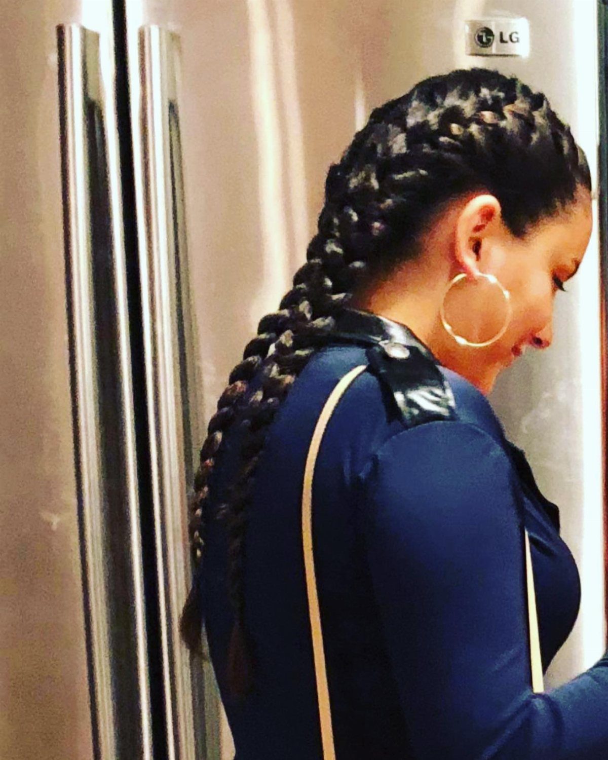 Two French braids merge into one long braid down a woman's back