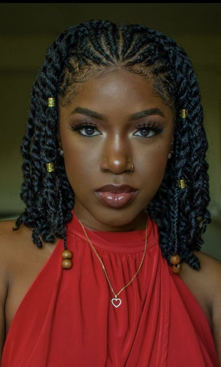 Woman with shoulder-length twists decorated with gold cuffs and wooden beads