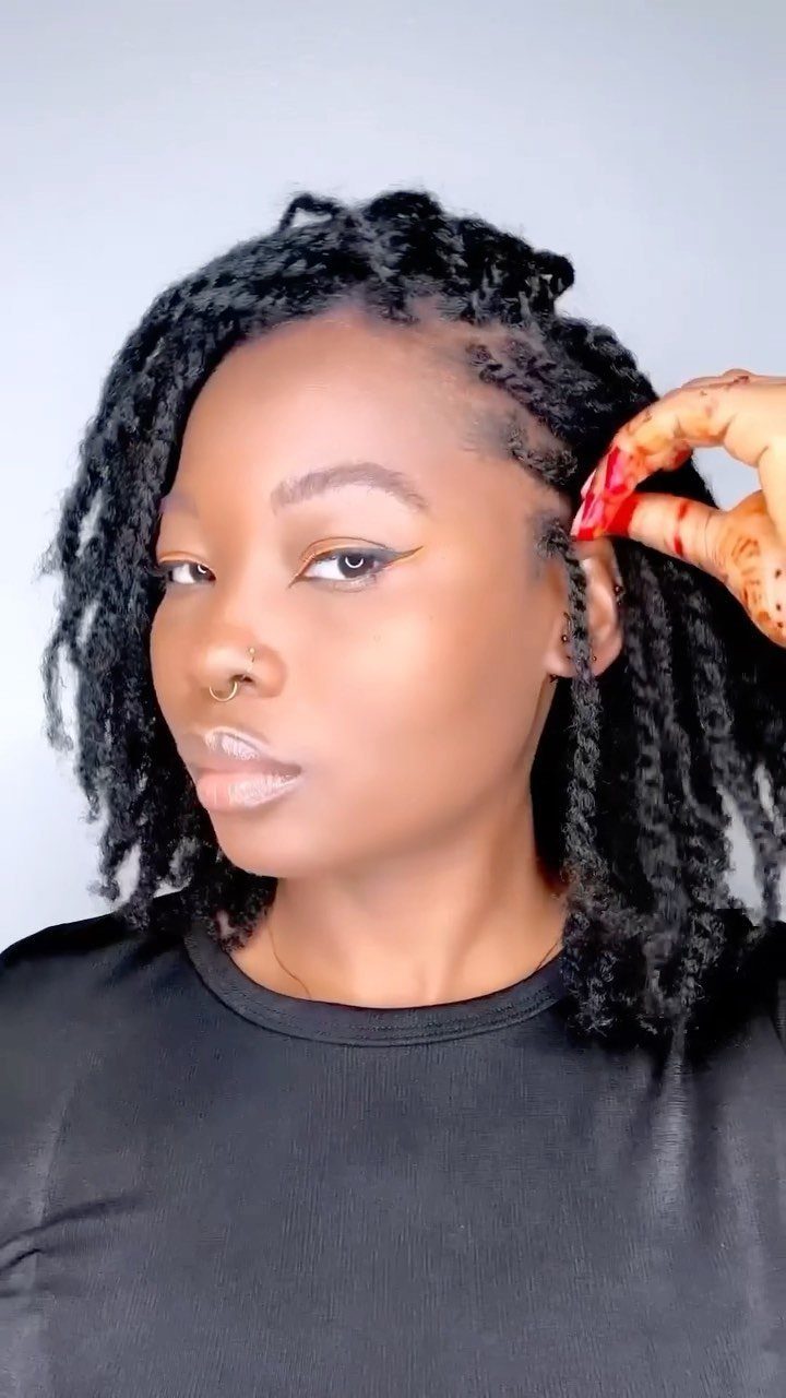 Person with long black two-strand twists worn loose around the head
