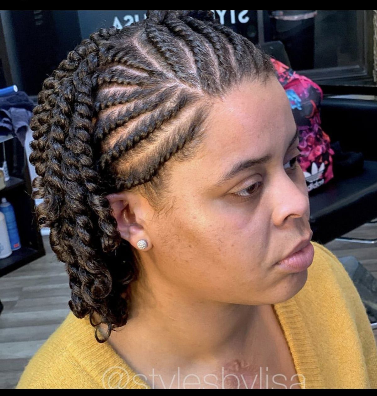 Side-parted natural hair twists arranged along visible scalp partings