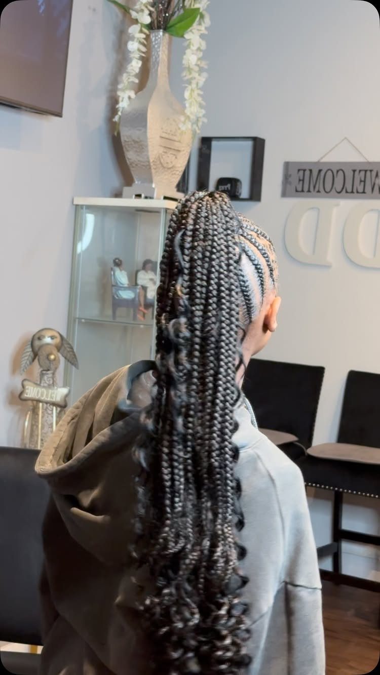 High braided ponytail with long black-and-silver braids and curled ends
