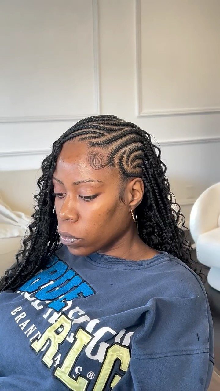 Woman showing small braids with curved cornrow patterns across her scalp
