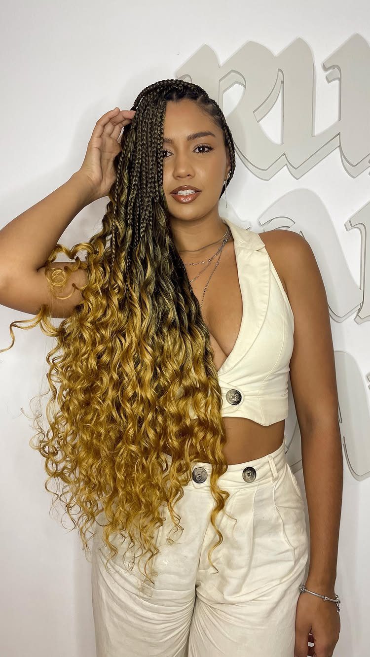 Woman displaying dark box braids with long blonde curly ends