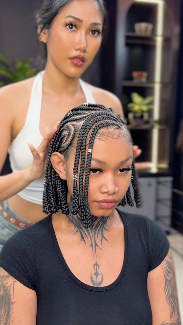 Woman displaying curved scalp braids with individual braids hanging at the sides