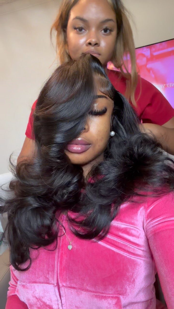 Woman displaying long, glossy dark hair in voluminous bouncy waves