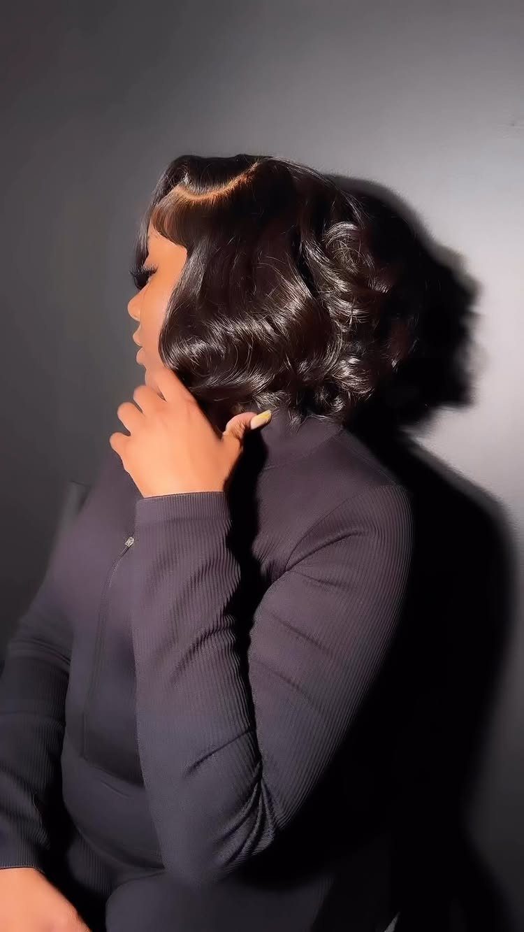 Glossy dark wavy jaw-length bob with a smooth, even edge